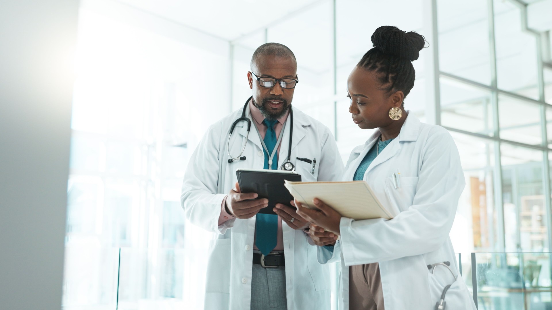 Black people, doctors and folder on meeting with tablet at clinic for telehealth, schedule and appointment. Hospital, employees and healthcare team for patient data, results and report on discussion
