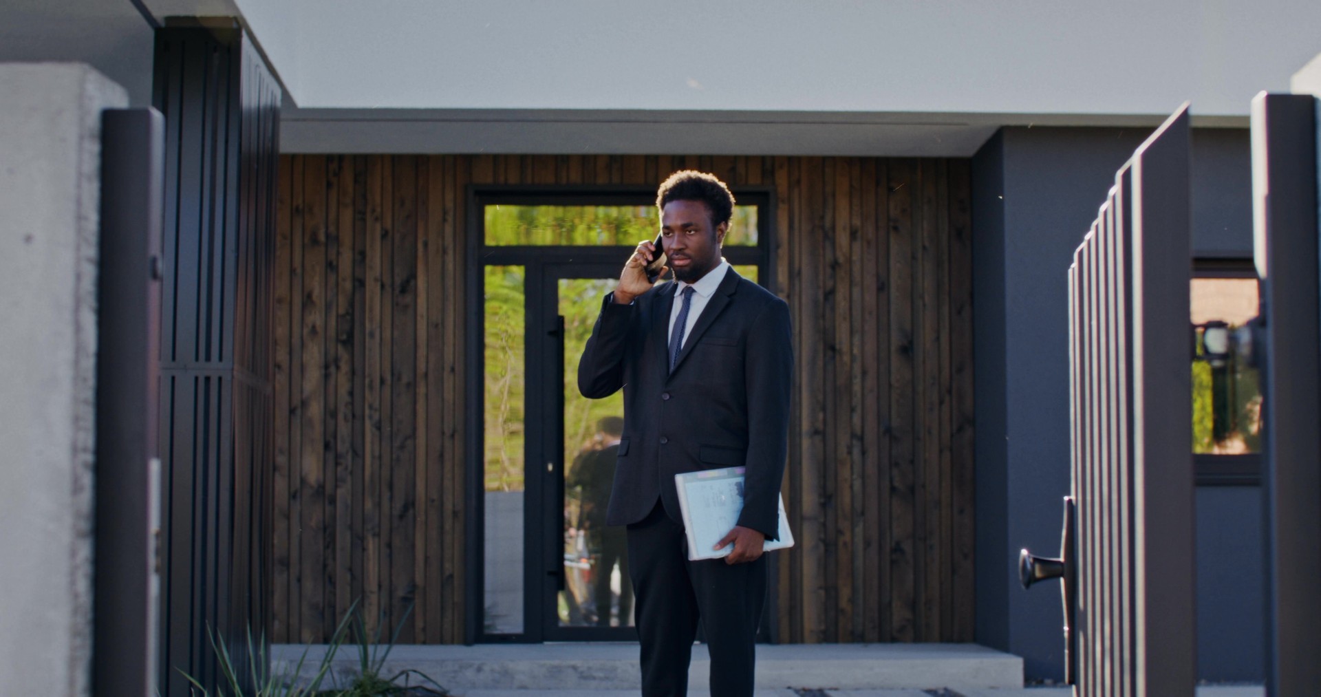 The real estate agent is talking on a mobile phone